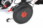 Rear wheel of Bangeran Pegasus Cerebral Palsy wheelchair with red freewheel lever.